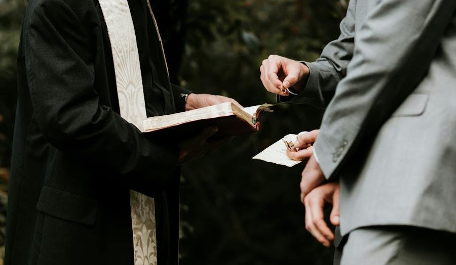 Man exchanging ring on wedding day