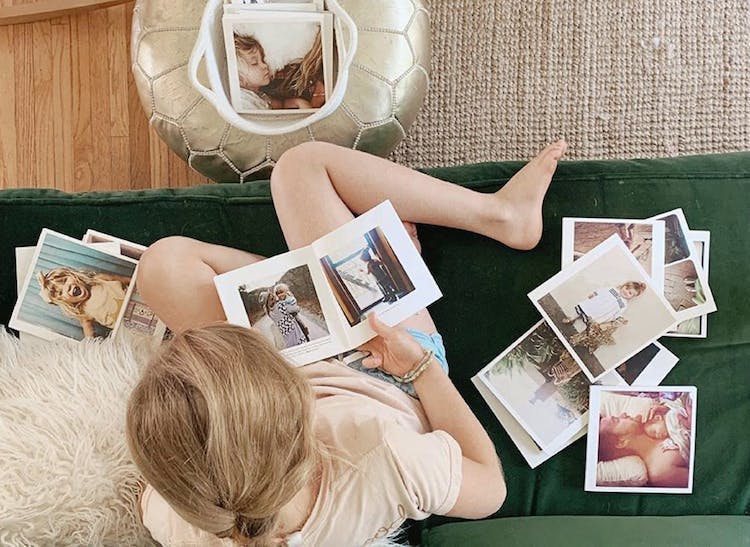 little girl flipping through Instagram photo books