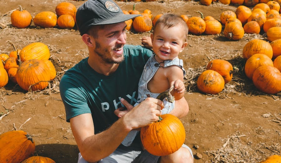 Dad with baby at pumpkin patch