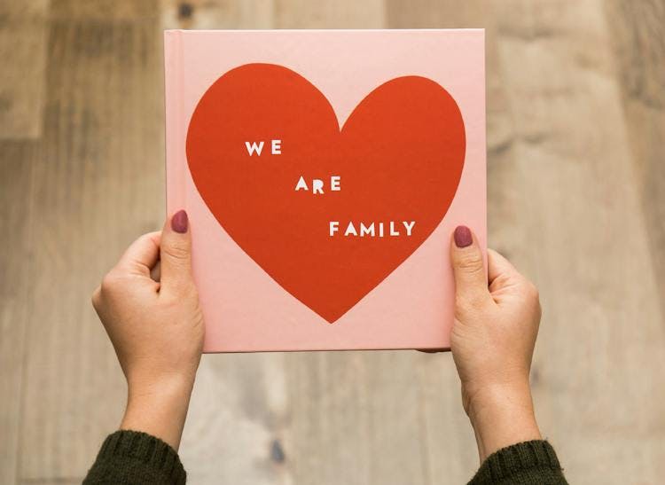 family photo album with designer cover that says we are family